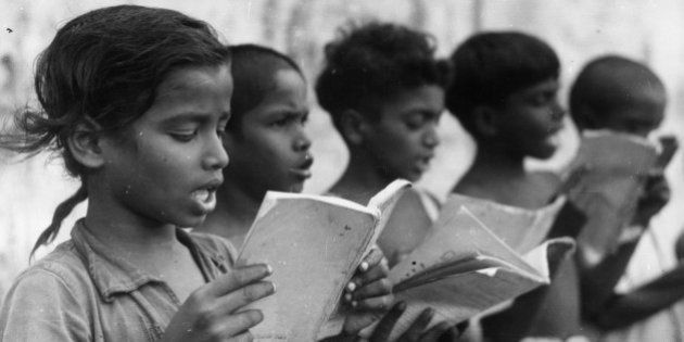 A group of Indian children singing in a central school which serves several villages around Mudichuri, Madras.