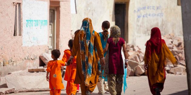 INDIA - MARCH 15: Indian women and girls dressed as wedding guests walking to the wedding in village of Rohet in Rajasthan, Northern India (Photo by Tim Graham/Getty Images)