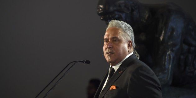 Force India Chairman Vijay Mallya delivers a speech next to a Force India Formula 1 Team car (not framed) with the new team livery that will adorn their cars during 2015 FIA Formula One World Championship during a presentation at the Soumaya Museum in Mexico City, on January 21, 2015. AFP PHOTO/RONALDO SCHEMIDT (Photo credit should read RONALDO SCHEMIDT/AFP/Getty Images)
