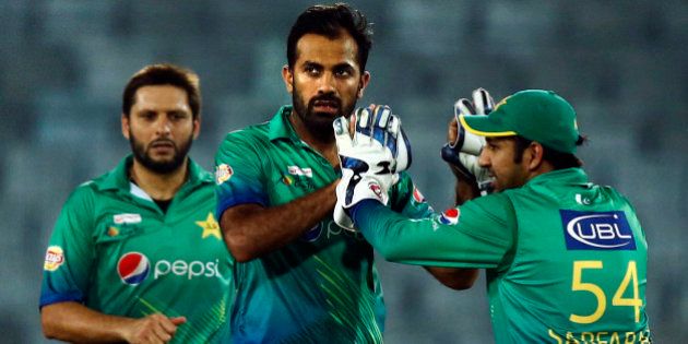 Pakistanâs Wahab Riaz, center, celebrates with his teammates after the dismissal of Sri Lankaâs captain Dinesh Chandimal during the Asia Cup Twenty20 international cricket match between them in Dhaka, Bangladesh, Friday, March 4, 2016. (AP Photo/A.M. Ahad)