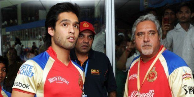 Sidhartha Mallya and his Dad, Vijay, closely watch a replay on TV at Feroz Shah Kotla Stadium, Delhi, April 26, 2011