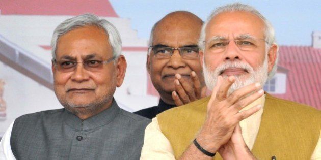 PATNA, INDIA - MARCH 12: Prime Minister Narendra Modi with Bihar Chief Minister Nitish Kumar during the Closing Ceremony of the Centenary Year Celebrations of the Patna High Court on March 12, 2016 in Patna, India. Modi said here that the 'quality of argument and judgement will improve with technology being used actively' in the courts. He also sought suggestions on making the bar, bench and courts tech-savvy by injecting digital technology in their functioning. (Photo by AP Dube/Hindustan Times via Getty Images)