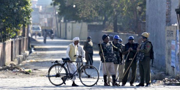 PANIPAT, INDIA - FEBRUARY 22: Heavy police force and Army jawan deployed at village Siwah after Jat agitation turned violent on February 22, 2016 in Panipat, India. Jats are agitating for quotas in jobs and want to be counted as a part of Other Backward Classes, a section that has 27% quotas in government jobs. (Photo by Parveen Kumar/Hindustan Times via Getty Images)