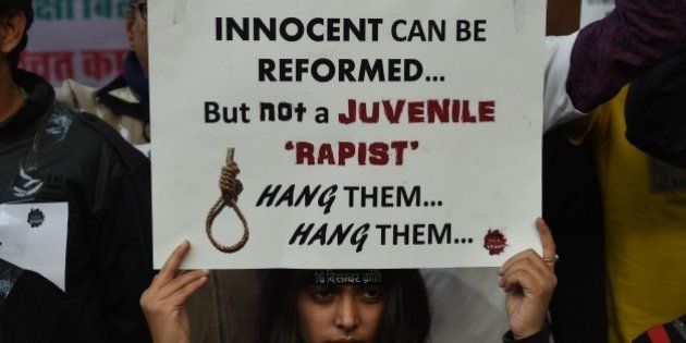 An Indian protester holds a placard during a demonstration against the release of a juvenile rapist in New Delhi on December 21, 2015. India's Supreme Court December 21, 2015 rejected an appeal against the release of the youngest convict in an infamous fatal gang-rape, sparking fury from the victim's parents who said the ruling was a betrayal of women. AFP PHOTO / Money SHARMA / AFP / MONEY SHARMA (Photo credit should read MONEY SHARMA/AFP/Getty Images)