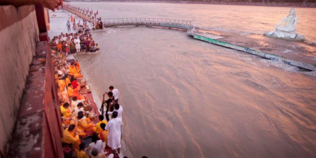 Worshippers and Yogi Sing at Sunset on Ganga The Gate At Paramartha Niketan,Rishikesh