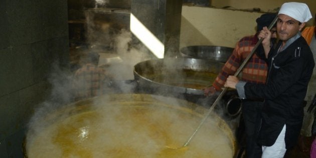 Vikas Khanna, master chef India host and executive chef of Junoon restaurant in New York, prepares food for a communal vegetarian meal, known as 'langar', at a community kitchen at the Sikh Shrine Golden temple in Amritsar on November 25, 2012. Khanna visited the city for a promotional event for an upcoming show. AFP PHOTO/ NARINDER NANU (Photo credit should read NARINDER NANU/AFP/Getty Images)