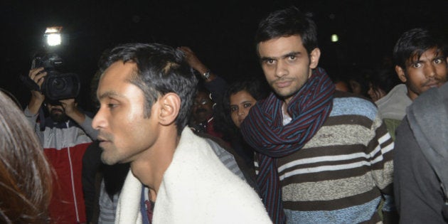 This photograph taken late on February 23, 2016 shows Indian student activist Umar Khalid (C) and Anirban Bhattacharya (L) walking through the campus of New Delhi's Jawaharlal Nehru University (JNU) on their way to surrendering to Indian authorities. Khalid and Bhattacharya are accused of sedition over a rally at which anti-India slogans were shouted. Students have accused Prime Minister Narendra Modi's right-wing nationalist government of misusing the British-era sedition law to stifle dissent. AFP PHOTO / AFP / STRDEL (Photo credit should read STRDEL/AFP/Getty Images)