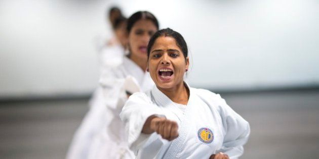 Women from the Delhi police force, undergo martial arts training at an institute in New Delhi, India, Tuesday, Nov. 25, 2014. The cadets will undergo rigorous training for up to three years and will then impart training to other policewomen who will be deployed in sensitive zones of Delhi to prevent eve teasing and other crimes against women. Tuesday marks the International Day for the Elimination of Violence against Women.(AP Photo/Saurabh Das)