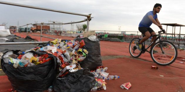 NEW DELHI, INDIA - MARCH 14: Garbage mess at the site of the Art of Living's World Culture Festival on the morning after the event, on March 14, 2016 in New Delhi, India. The three-day gala, which ended on March 13, saw a footfall of over 2 lakh visitors from scores of countries across the world. In the wake of the controversial World Culture Festival, the thousand volunteers, Sri Sri Ravi Shankar said would clean up the venue, could not be found. Instead, rag-pickers and contractors are making their way through the mess accumulated over three days of the festival. The WCF was held on Yamuna's floodplains, a fragile wetland ecology. The festival was challenged in the National Green Tribunal, which accepted that the event had damaged the floodplains, but allowed it against an initial compensation of Rs. 5 crore. (Photo by Sushil Kumar/Hindustan Times via Getty Images)