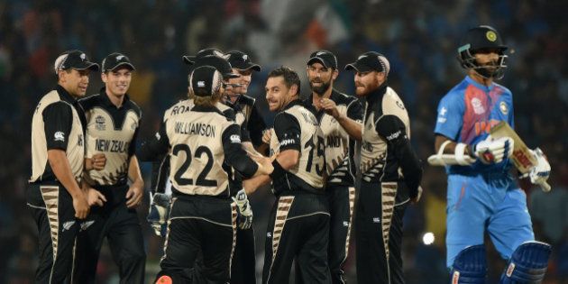New Zealand bowler Nathan McCullum (4th R) celebrates with team mates after the wicket of India's batsman Shikhar Dhawan (R) during the World T20 cricket tournament match between India and New Zealand at The Vidarbha Cricket Association Stadium in Nagpur on March 15, 2016. / AFP / PUNIT PARANJPE (Photo credit should read PUNIT PARANJPE/AFP/Getty Images)