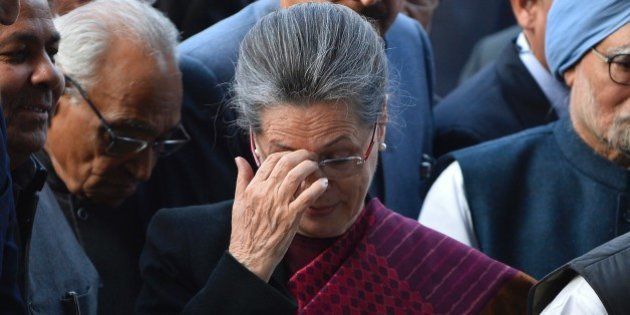 President of India's Congress Party Sonia Gandhi gestures as she arrives for a media briefing inside All India Congress Committee (AICC) headquarters in New Delhi on December 19, 2015, after a court appearance by her and Rahul Gandhi. An Indian court granted bail to opposition leaders Sonia and Rahul Gandhi minutes after they arrived at a Delhi court, over allegations they illegally acquired a newspaper's assets. AFP PHOTO / CHANDAN KHANNA / AFP / Chandan Khanna (Photo credit should read CHANDAN KHANNA/AFP/Getty Images)
