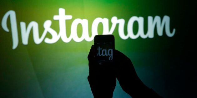A journalist makes a video of the Instagram logo using the new video feature at Facebook headquarters in Menlo Park, Calif., Thursday, June 20, 2013. (AP Photo/Marcio Jose Sanchez)