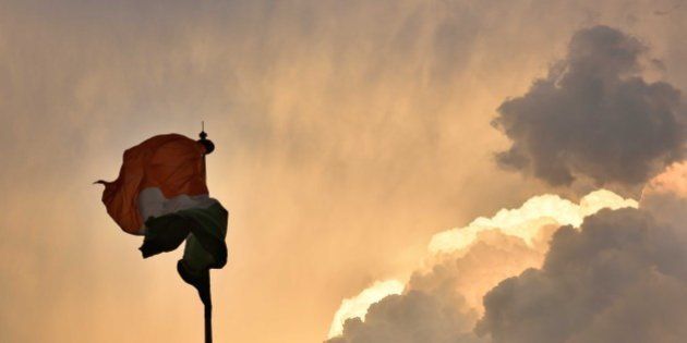 NEW DELHI, INDIA - MARCH 12: The Indian flag makes various forms due to fast winds as dark clouds engulfed the capital on March 12, 2016 in New Delhi, India. Despite the drizzle and heavy rainfall in Delhi, both minimum and maximum temperature rose marginally in Gurgaon. The IMD said the maximum temperature rose to 33 degrees Celsius and it was 2 degrees more than Thursday. The minimum temperature was recorded at 16.9 degrees Celsius, and it was 3 degrees more than the previous day. An official of the IMD said that temperature will fall by 3 to 4 degrees in north-western India as moderate to scattered rainfall is expected in certain parts. (Photo by Saumya Khandelwal/Hindustan Times via Getty Images)