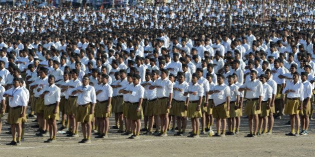 Indian right wing Rashtriya Swayamsevak Sangh (RSS) volunteers give a traditional salute at a rally in Pune some 135 kms from Mumbai on January 3, 2016. Over 150,000 RSS voluntreers are attending a day long congregation'Shivashakti Sangam', the largest in recent years. AFP PHOTO/ INDRANIL MUKHERJEE / AFP / INDRANIL MUKHERJEE (Photo credit should read INDRANIL MUKHERJEE/AFP/Getty Images)