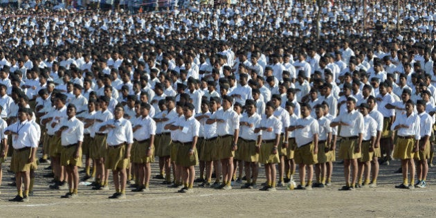 Indian right wing Rashtriya Swayamsevak Sangh (RSS) volunteers give a traditional salute at a rally in Pune some 135 kms from Mumbai on January 3, 2016. Over 150,000 RSS voluntreers are attending a day long congregation'Shivashakti Sangam', the largest in recent years. AFP PHOTO/ INDRANIL MUKHERJEE / AFP / INDRANIL MUKHERJEE (Photo credit should read INDRANIL MUKHERJEE/AFP/Getty Images)