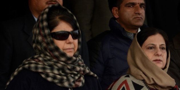 Peoples Democratic Party (PDP) president Mehbooba Mufti (L) looks on during celebrations marking India's Republic Day at Bakshi Stadium in Srinagar on January 26, 2016. The anniversary of the partition of the sub-continent in 1947 is often a tense period in Kashmir, a picturesque Himalayan territory which has been divided between India and Pakistan since the end of British colonial rule. AFP PHOTO / TAUSEEF MUSTAFA / AFP / TAUSEEF MUSTAFA (Photo credit should read TAUSEEF MUSTAFA/AFP/Getty Images)