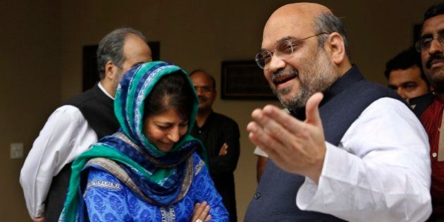 India's ruling Bharatiya Janata Party (BJP) president Amit Shah, right, gestures to the media after a meeting with Kashmirâs regional Peoples' Democratic Party (PDP) leader Mehbooba Mufti, left in blue, in New Delhi, India, Tuesday, Feb. 24, 2015. The BJP and the PDP Tuesday finalized an agreement to form a coalition government in Kashmir, the first time the Hindu nationalist party will share a leadership position in the predominantly Muslim region. (AP Photo / Manish Swarup)
