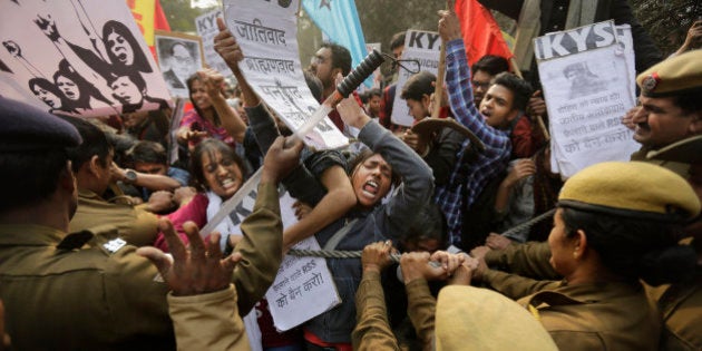 Policemen try to stop Indian students as they march towards the office of Hindu nationalist Rashtriya Swayamsevak Sangh (RSS) or the National Volunteers Association's office during a protest against the death of 26-year-old doctoral student Rohith Vemula in New Delhi, India, Saturday, Jan. 30, 2016. Saturday marked the birthday of Vemula whose body was found hanging in a hostel room, on January 17 weeks after he along with four others, was barred from using some facilities at his university in the southern tech-hub of Hyderabad.(AP Photo/Altaf Qadri)