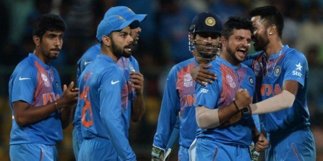 India's bowler Suresh Raina(2R)celebrates with teammates after taking the wicket of Bangladesh batsman Sabbir Rahman during the World T20 cricket tournament match between India and Bangladesh at The Chinnaswamy Stadium in Bangalore on March 23, 2016. Bangladesh is chasing a target of 146 runs scored by India with a loss of 7 wickets. / AFP / MANJUNATH KIRAN (Photo credit should read MANJUNATH KIRAN/AFP/Getty Images)