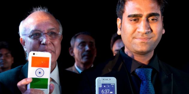 Mohit Goel, right, Director of Ringing Bells Pvt. Ltd., and Ashok Chadha, left, spokesperson, show a Freedom 251 smartphone, which is to be priced at Rs 251 or $3.6 approximately, during its release in New Delhi, India, Wednesday, Feb. 17, 2016. (AP Photo/Saurabh Das)