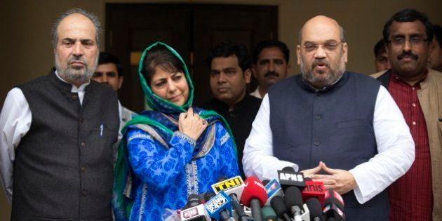 India's ruling Bharatiya Janata Party (BJP) president Amit Shah, right, addresses the media after a meeting with Kashmirâs regional Peoples' Democratic Party (PDP) leader Mehbooba Mufti, second left in blue, in New Delhi, India, Tuesday, Feb. 24, 2015. The BJP and the PDP Tuesday finalized an agreement to form a coalition government in Kashmir, the first time the Hindu nationalist party will share a leadership position in the predominantly Muslim region. (AP Photo / Manish Swarup)