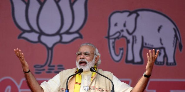 India's Prime Minister Narendra Modi gestures as he addresses an election rally at Majuli Island on March 26, 2016, ahead of state assembly elections in Assam. Thousands of Indian voters will elect legislators for the 126 seats contested in 25,000 polling stations in the north-eastern state of Assam in two phases on April 4 and 11. / AFP / Biju BORO (Photo credit should read BIJU BORO/AFP/Getty Images)