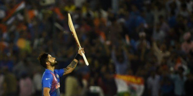 India's Virat Kohli celebrates after victory in the World T20 cricket tournament match between India and Australia at The Punjab Cricket Stadium Association Stadium in Mohali on March 27, 2016. / AFP / MONEY SHARMA (Photo credit should read MONEY SHARMA/AFP/Getty Images)