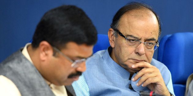 NEW DELHI, INDIA - MARCH 10: Finance Minister Arun Jaitley along with Minister of Petroleum and Natural Gas Dharmendra Pradhan, during the press conference at Cabinet briefing at Press Information Bureau at Shastri Bhawan on March 10, 2016 in New Delhi, India. Finance Minister raked up the Bofors case reminding Rahul Gandhi of Ottavio Quattrocchi's escape to hit back at him for his attack on the government over liquor baron Vijay Mallya leaving the country despite owing over Rs. 9,000 crore to banks. (Photo by Raj K Raj/Hindustan Times via Getty Images)