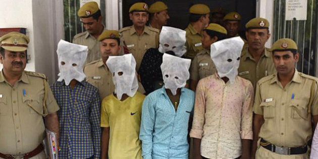 NEW DELHI, INDIA - MARCH 25: Delhi Police arrest 5 accused after a 40-year-old dentist Pankaj Narang was allegedly beaten to death by a group of around 15 persons, including at least four juveniles, following a dispute in West Delhi's Vikaspuri area, on March 25, 2016 in New Delhi, India. According to the police, a little past midnight, Dr. Narang was playing cricket with his son and nephew at his home, celebrating India's victory over Bangladesh in the World Twenty20 tournament. The men dragged Narang out of his house on the road and beat him up with hockey sticks and bats till he died. (Photo by Ravi Choudhary/Hindustan Times via Getty Images)