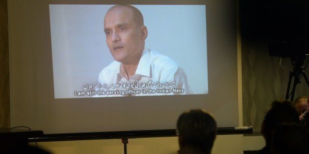 Members of the media watch a projection of a video showing arrested man Kulbhushan Yadav, who is suspected of being an Indian spy, during a press conference in Islamabad on March 29, 2016.Pakistan protested to India after arresting a man suspected of being an Indian spy, sparking a new diplomatic tiff between the nuclear-armed neighbours. The man was arrested during a raid in the southwestern province of Balochistan, Pakistani media reports said quoting local security officials, calling him an agent with India's Research and Analysis Wing (RAW) intelligence agency. / AFP / AAMIR QURESHI (Photo credit should read AAMIR QURESHI/AFP/Getty Images)