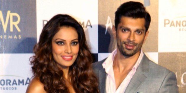 Indian Bollywood actors Bipasha Basu (L) and Karan Singh Grover pose for a photograph during a promotional event for the forthcoming Hindi film 'Alone' directed by Bhushan Patel in Mumbai on December 9, 2014. AFP PHOTO / STR (Photo credit should read STRDEL/AFP/Getty Images)