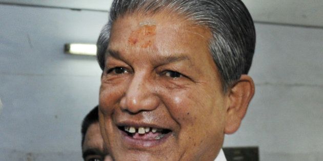 DEHRADUN, INDIA - MAY 7: Uttrakhand Chief Minister Harish Rawat showing ink stained finger after casting his vote at polling centre during 8th phase of Lok Sabha election on May 7, 2014 in Dehradun, India. 1,737 candidates are contesting on 64 seats in seven states in eighth phase of Lok Sabha election. (Photo by Rishi Ballabh/Hindustan Times via Getty Images)