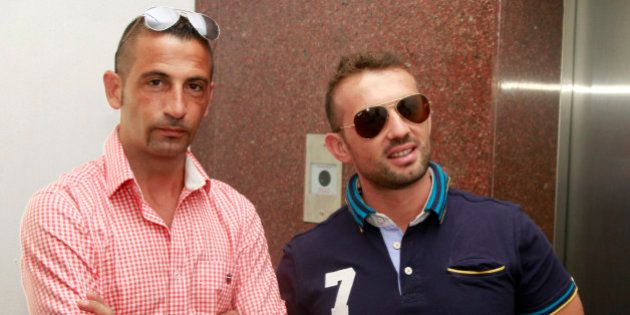 Italian sailors Massimiliano Latorre (L) and Salvatore Girone wait to board an elevator to reach the police commissioner's office in the southern Indian city of Kochi December 18, 2012. Italy's Defense Minister Giampaolo Di Paolo on Sunday visited two Italian marines accused of killing two fishermen off the coast of Kerala, stepping up pressure to allow the men home for Christmas after the case flared into a diplomatic spat. The sailors, members of a military security team protecting the cargo ship Enrica Lexie from pirate attacks, open fired on a fishing boat they mistook for a pirate craft in February. The killings of the unarmed fishermen triggered outrage in India. REUTERS/Sivaram V (INDIA - Tags: POLITICS MILITARY)