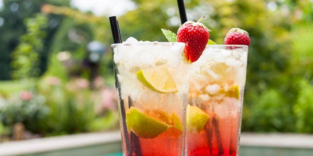 Strawberry Caipirinha with fresh mint and strawberry in glasses
