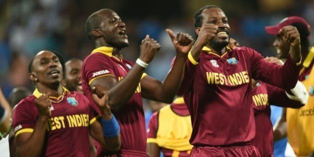 West Indies's captain Darren Sammy(C) Dwayne Bravo(L)and Chris Gayle(R)celebrate after victory in the World T20 cricket tournament second semi-final match between India and West Indies at The Wankhede Stadium in Mumbai on March 31, 2016. / AFP / INDRANIL MUKHERJEE (Photo credit should read INDRANIL MUKHERJEE/AFP/Getty Images)