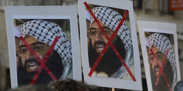 Indian activists carry placards of the chief of Jaish-e-Mohammad, Maulana Masood Azhar during a protest against the attack on the air force base in Pathankot, in Mumbai on January 4, 2016. Indian troops backed by helicopters searched an air force base January 4, after a weekend of fierce fighting with suspected Islamic insurgents in which seven soldiers and at least four attackers were killed. AFP PHOTO/ Indranil MUKHERJEE / AFP / INDRANIL MUKHERJEE (Photo credit should read INDRANIL MUKHERJEE/AFP/Getty Images)