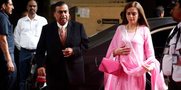 Mukesh Ambani, chairman and managing director of the Reliance Industries Ltd., and his wife Nita arrive for the 41st Reliance Industries AGM meet in Mumbai, India, Friday, June 12, 2015. (AP Photo/Rajanish Kakade)
