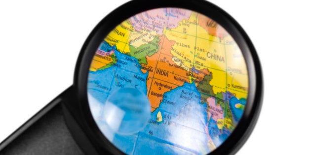 India on globe viewed through a magnifying glass