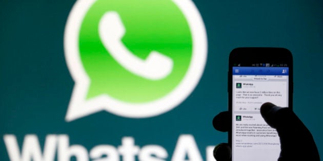 A Whatsapp App logo is seen behind a Samsung Galaxy S4 phone that is logged on to Facebook in the central Bosnian town of Zenica, February 20, 2014. Facebook Inc will buy fast-growing mobile-messaging startup WhatsApp for $19 billion in cash and stock in a landmark deal that places the world's largest social network closer to the heart of mobile communications and may bring younger users into the fold. REUTERS/Dado Ruvic (BOSNIA AND HERZEGOVINA - Tags: BUSINESS)