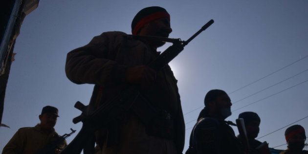 Indian police personnel stand alert near the airforce base in Pathankot on January 5, 2016. Umbrella group of Pakistani proxy jihadist outfits fighting in Indian-controlled Kashmir, the United Jihad Council, claimed responsibility for the attack in a statement issued to the media on January 4, after a weekend of fierce fighting with insurgents left seven soldiers dead. AFP PHOTO/ NARINDER NANU / AFP / NARINDER NANU (Photo credit should read NARINDER NANU/AFP/Getty Images)