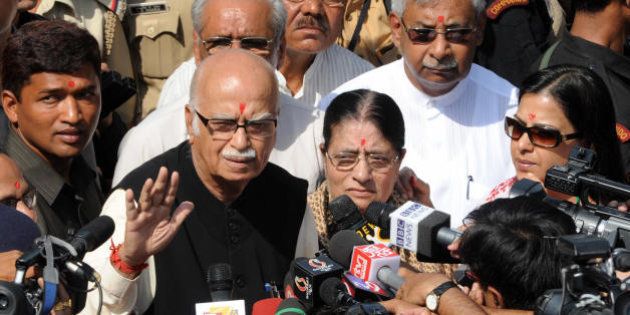 Prime ministerial candidate for the Bharatiya Janata Party (BJP), L.K.Advani (L), accompanied by his wife Kamla Advani (C) and their daughter Pratibha (R), interacts with the media after casting his vote in Ahmedabad on April 30, 2009. Indian voters are going to the polls in five phases across the country for general elections from April 16-May 13. AFP PHOTO/ Sam PANTHAKY (Photo credit should read SAM PANTHAKY/AFP/Getty Images)