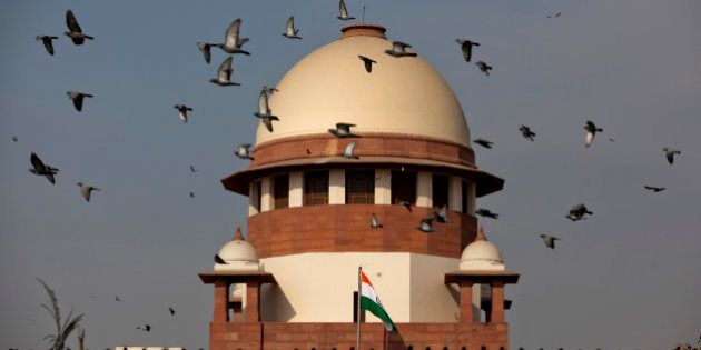 Pigeons fly past the dome of India's Supreme Court building in New Delhi, India, Tuesday, Feb. 2, 2016. India's top court on Tuesday agreed to re-examine a colonial-era law that makes homosexual acts punishable by up to a decade in prison. Gay activists cheered the court decision and said they were hopeful that the verdict would ultimately go in their favor, giving them a chance to live openly. (AP Photo/Tsering Topgyal)