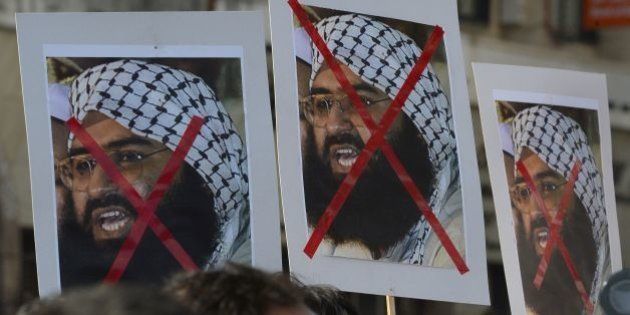 Indian activists carry placards of the chief of Jaish-e-Mohammad, Maulana Masood Azhar during a protest against the attack on the air force base in Pathankot, in Mumbai on January 4, 2016. Indian troops backed by helicopters searched an air force base January 4, after a weekend of fierce fighting with suspected Islamic insurgents in which seven soldiers and at least four attackers were killed. AFP PHOTO/ Indranil MUKHERJEE / AFP / INDRANIL MUKHERJEE (Photo credit should read INDRANIL MUKHERJEE/AFP/Getty Images)