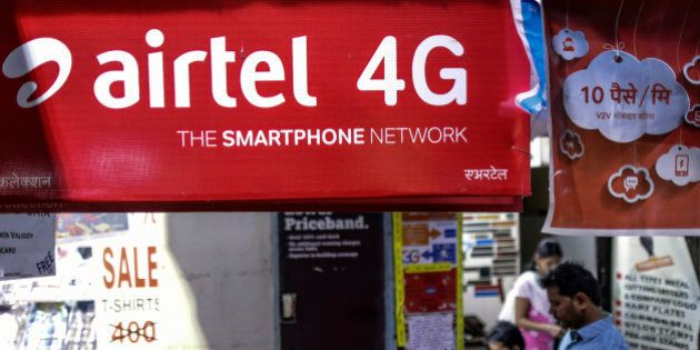 An advertisment for Bharti Airtel Ltd. sits outside a sim card vendor's stall in Mumbai, India, on Monday, Oct. 19, 2015. Bharti, Indias largest wireless carrier, is scheduled to announce earnings on Oct. 26. Photographer: Dhiraj Singh/Bloomberg via Getty Images