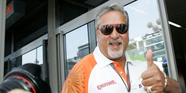 Force India team principal Vijay Mallya gives the thumb up sign after Force India driver Adrian Sutil of Germany was the fastest in final practice ahead of qualifying for Sunday's Italian Formula One Grand Prix, at the Monza racetrack, Saturday, Sept. 12, 2009. (AP Photo/Alberto Pellaschiar)