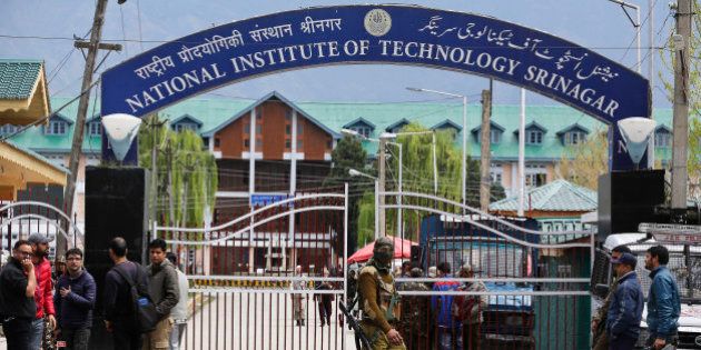 An Indian security personnel guards the entrance to the National Institute of Technology (NIT), in Indian controlled Kashmir, Thursday, April 7, 2016. A clash took place between students of Kashmiri origin and others during the West Indies-India World Cup T20 semi-final match, after Kashmiri students allegedly celebrated India's loss. Classes had to be suspended after several students sustained injuries. (AP Photo/Mukhtar Khan)