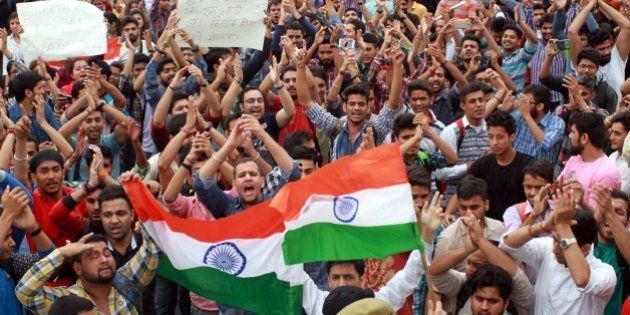 JAMMU, INDIA - APRIL 6: University students holding national flag as they shout slogans during a protest against ongoing unrest at the National Institute of Technology (NIT) in Srinagar, on April 6, 2016 in Jammu, India. Trouble erupted at the NIT after India lost the World T20 semi-final match to West Indies on March 31. Some engineering students from outside the state claimed Kashmiri students had chanted anti-India slogans and burst firecrackers after India lost. (Photo by Nitin Kanotra/Hindustan Times via Getty Images)