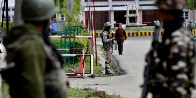 Indian paramilitary soldiers stand guard near the main gate of the National Institute of Technology (NIT), in Indian controlled Kashmir, Thursday, April 7, 2016. A clash took place between students of Kashmiri origin and others during the West Indies-India World Cup T20 semi-final match, after Kashmiri students allegedly celebrated India's loss. Classes had to be suspended after several students sustained injuries. (AP Photo/Mukhtar Khan)