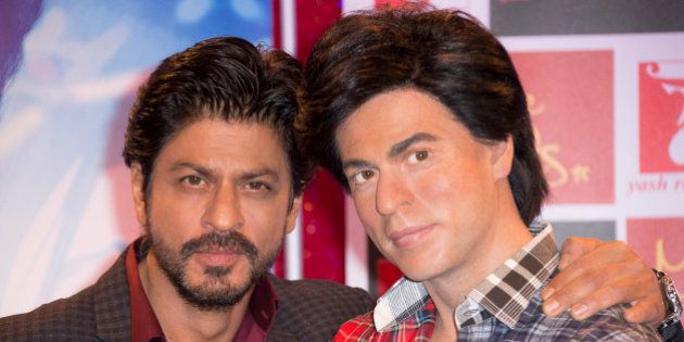 Actor Shah Rukh Khan, left, poses for photographers with his Madame Tussauds wax figure in central London ahead of the launch of Khan's new film 'Fan', Wednesday, April 13, 2016. (Photo by Joel Ryan/Invision/AP)