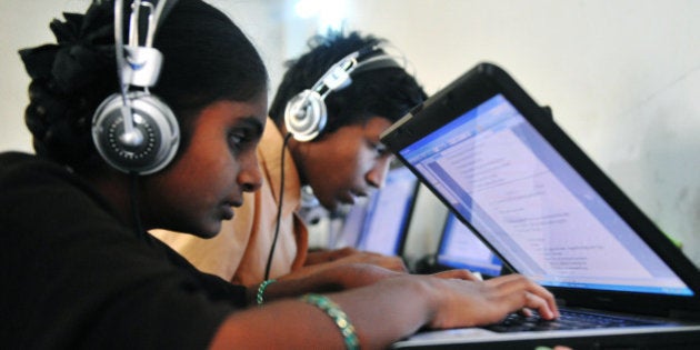 Visually impaired Indian students take the Intermediate (10+2) Political Science (Civics) examination on laptops at an examination centre on the outskirts of Hyderabad on March 15, 2010. Nethra Vidyalaya Junior college provides free education exclusively for low socio-econimic underprivileged blind students. The question paper was scanned and recorded in the laptops of 55 students who listened to the questions through their headphones and typed the answers. AFP PHOTO/Noah SEELAM (Photo credit should read NOAH SEELAM/AFP/Getty Images)